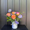 Welcome summer with this petite arrangement in a bright seasonal palette. Arrangement