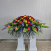 This Casket Spray Includes Red Gerbera Daisy, Bells of Ireland, Blue Delphinium