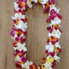 A bright, island-inspired orchid lei that feels like a warm sunset around