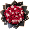 Bouquet of red and pale pink roses wrapped in black paper