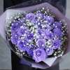 Bouquet of purple roses with white baby's breath in lavender wrap