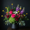 This high style bouquet is modern and classy. The bright colors are
