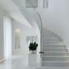 White orchid plant in a silver pot on a pedestal in a modern stairwell