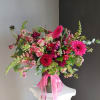 This beautiful flower arrangement of fresh mixed seasonal blooms is made by