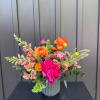 An energetic mix of orange and vivid hot pinks. This arrangement comes