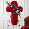 Red floral cross on a stand with roses and blue accents