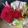 Velvety red roses take center stage in this red rose arrangement, surrounded