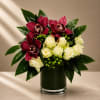 Sophisticated, dramatic, and undeniably luxurious, Noir Orchid Elegance is a couture-inspired floral