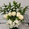 White roses and alstroemeria in a square glass vase