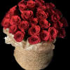 Bouquet of red roses in a woven basket wrapped with white paper