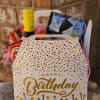 Birthday gift basket with wine, snacks, and a decorated box