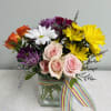 This bouquet is made up of assorted daisy stems and spray roses.
