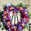 Heart-shaped floral wreath with pink, purple, and red blooms