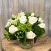 Glass vase filled with white roses, white lisianthus, green dianthus, mini green
