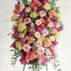 A large upright standing spray that reads as both a heartfelt tribute
