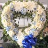 A heart-shaped floral wreath that reads as a gentle, ceremonial tribute-perfect for