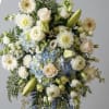 A serene spray of white and pale blue blooms creates a gentle