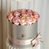 A delicate blend of ivory, and soft pink roses beautifully arranged in