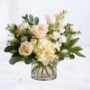 Linen Orchard is a refined garden-style arrangement featuring soft roses, hydrangea, and