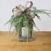A rustic wooden lantern topped with a taupe-and-cream plaid bow makes a