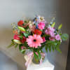 This beautiful flower arrangement of fresh mixed seasonal blooms is made by