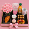 A compact bouquet of pale pink roses paired with a celebratory breakfast