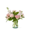 A rosy bouquet of roses, stock, carnations, and alstromeria arranged in a