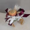 A compact dried corsage built to make the person you're thinking of