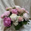 A lush garden feel of blush pink and white peonies creates an