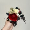 A striking red and white wrist corsage that reads modern and romantic