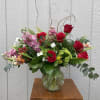Bright red roses and blushing pink stock create an immediately romantic, celebratory