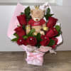 Bouquet of red roses with a teddy bear and chocolates in pink wrapping