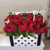 Red rose arrangement in a polka-dot gift box with pearl trim
