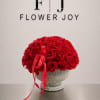 A luxurious arrangement of deep red roses in a vintage silver vase