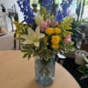 Tall blue delphinium spikes give this Summer Meadow arrangement its eye-catching vertical