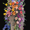 A breathtaking angel-wing tribute overflowing with vibrant lilies, roses, and seasonal blooms.