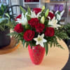 Deep red roses paired with crisp white lilies create a romantic floral