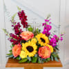 A crystal cross surrounded by vibrant blooms is a reminder of caring