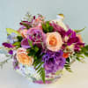 A lovely keepsake flower pot will be filled with seasonal purple and