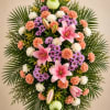 Pink lilies form the graceful focal point of this sympathy standing spray