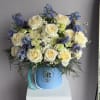 This vibrant flower arrangement combines cheerful Daisies, elegant Irises, romantic Roses, charming