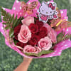 A playful cluster of pink and red roses tied into a rounded