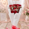 12 Red Roses Wrapped in Paper with a Decorative Bow