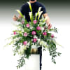 Towering white calla lilies rise above a lush cloud of magenta roses