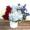 A patriotic display of flowers to celebrate the holiday. Approx 12"x12"