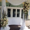 A soft, romantic ceremony arrangement in white and blush pink sets a