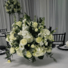 A lavish white centerpiece that reads as timeless elegance-perfect for a wedding