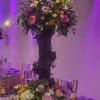 A towering, layered centerpiece that reads as celebration the moment she walks