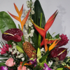 Striking vertical movement and bold tropical color make this flower arrangement a
