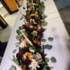 A lush, low centerpiece designed to run the length of a banquet